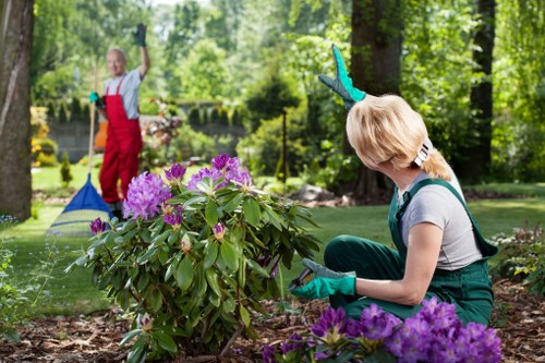 Garden maintenance crew with protective gear and machinery